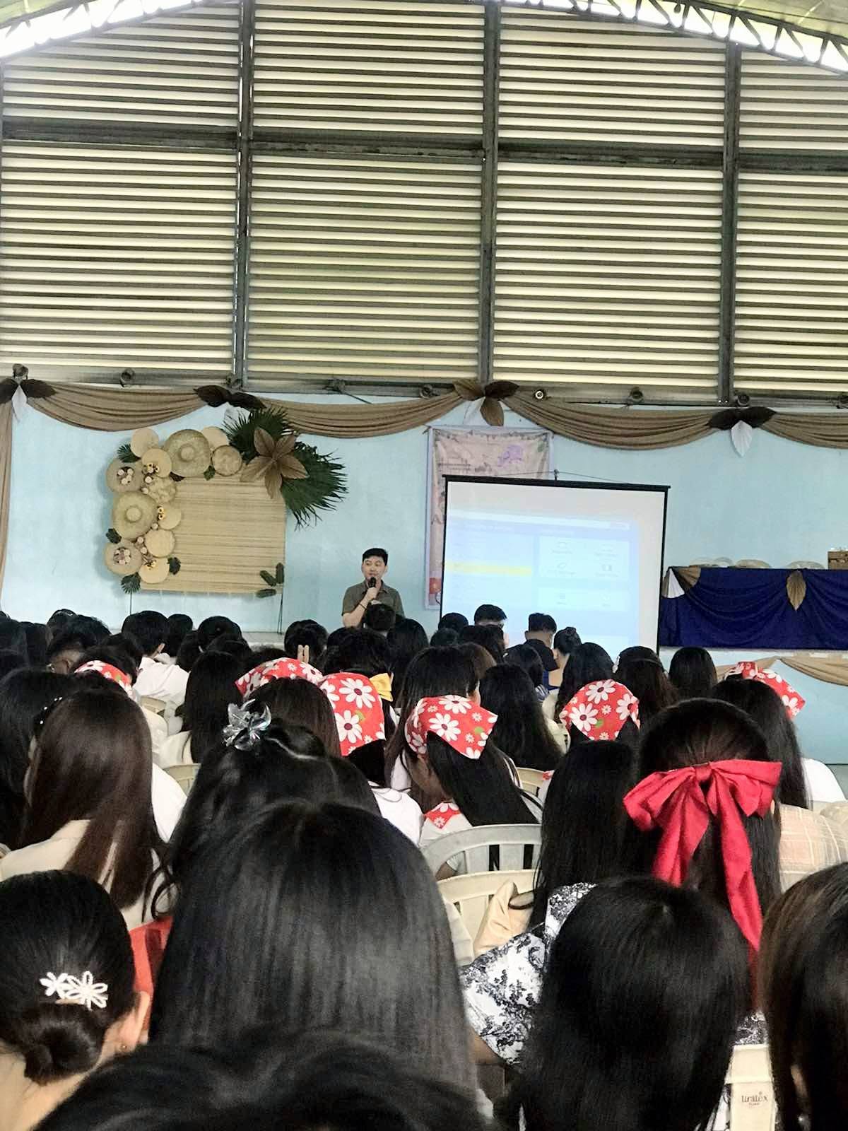 Wide view of the College of Mary Immaculate student audience with Jayson presenting on stage