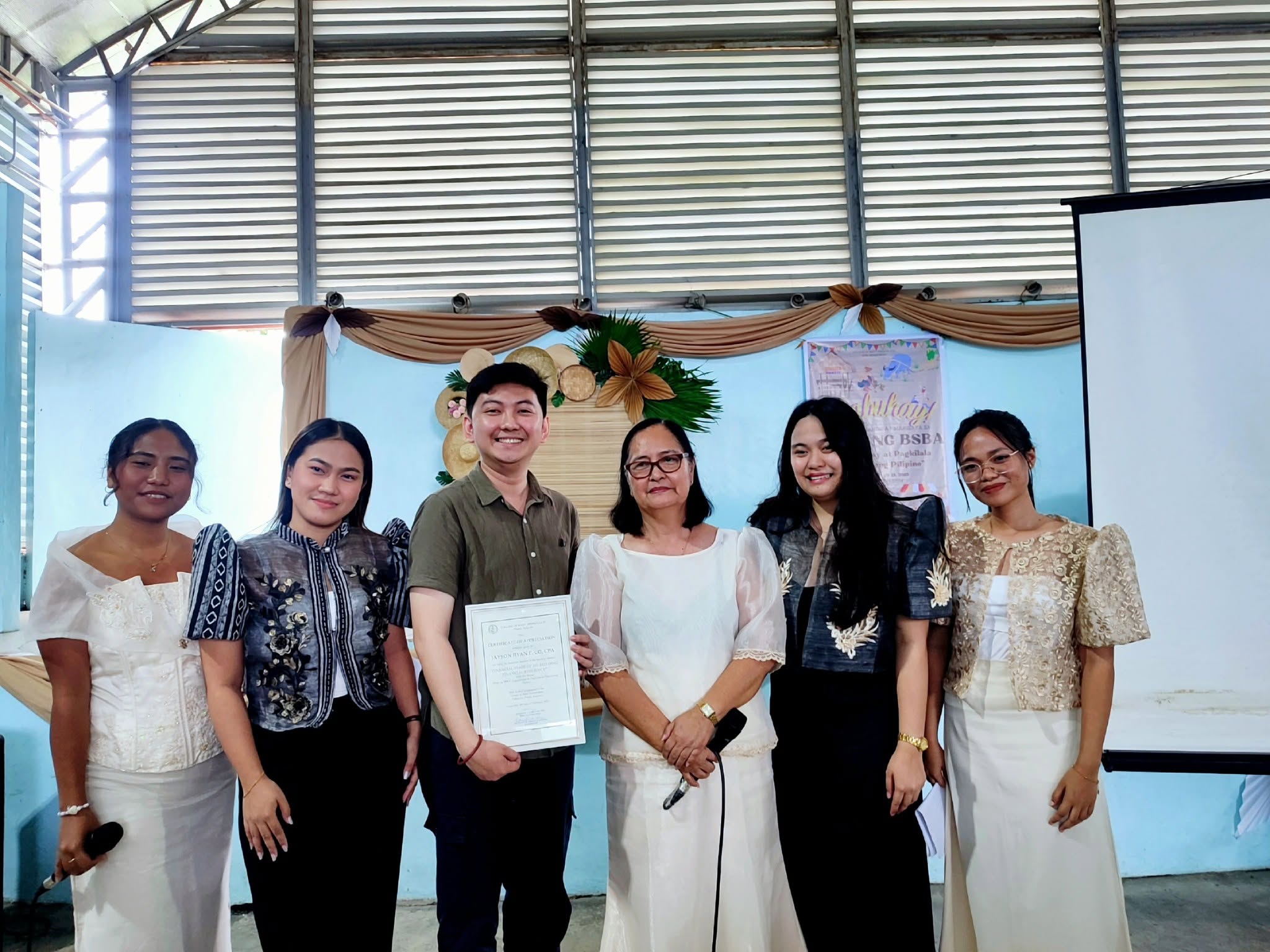 Jayson Ryan Co holding his Certificate of Appreciation with College of Mary Immaculate faculty and students after the Finance Talk 101 seminar